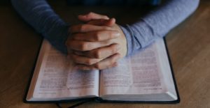 prayer-male-hands-and-bible-red